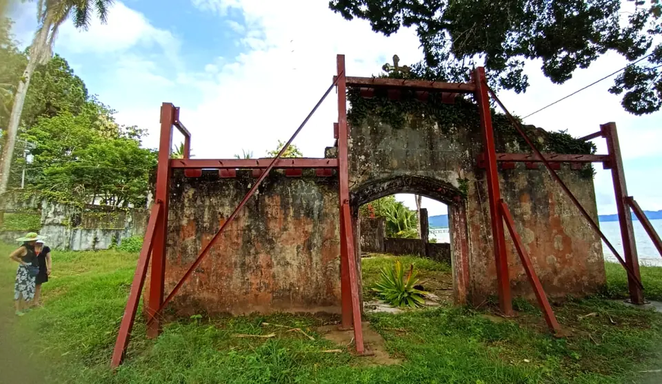 Rusted gate and stone wall of the old penal colony on Coiba Island